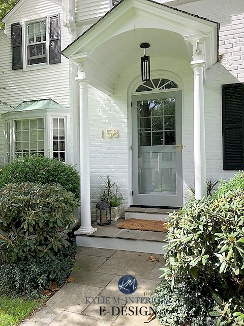 Aged copper roof, painted white brick exterior, black shutters and benjamin moore gray front door. Kylie M Interiors Edesign, online paint color consultant