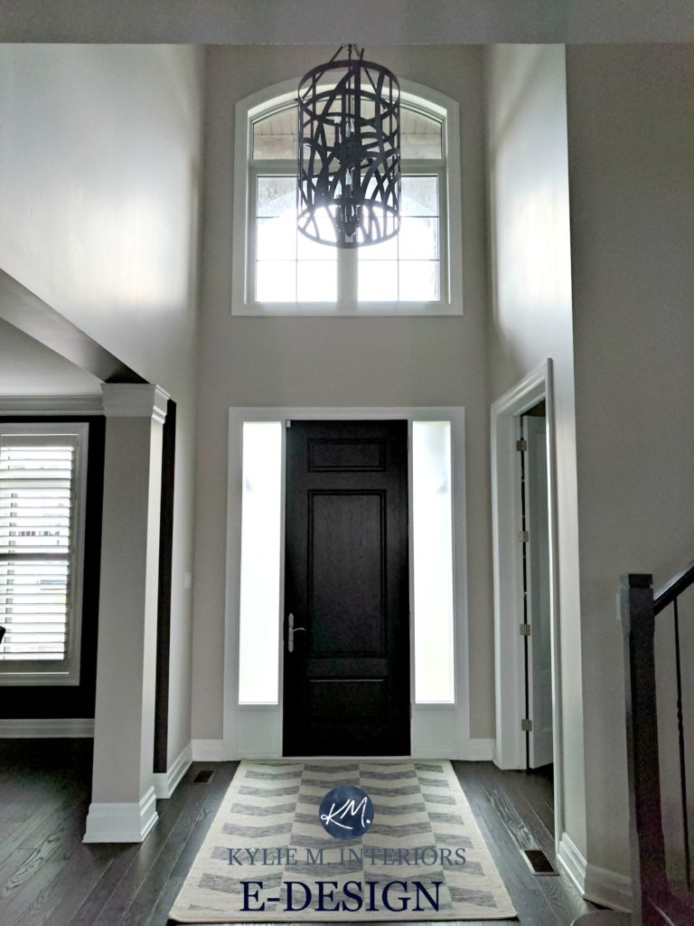 Benjamin Moore Collingwood in 2 storey entryway or foyer with dark wood door and white trim. Kylie M Interiors E-design and online color consulting
