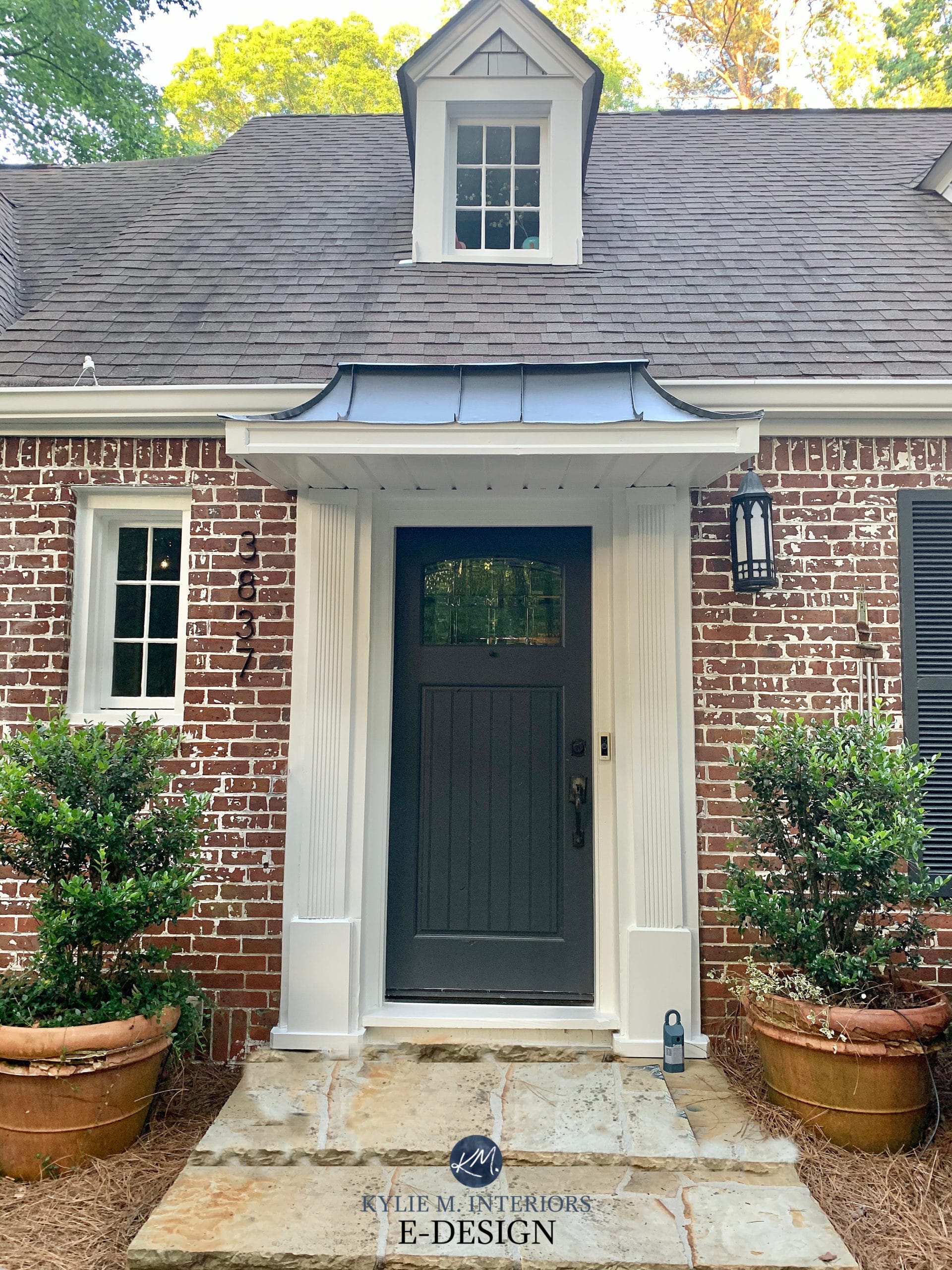 Exterior with brick and gray roof. Cheating heart painted front door, Pure White trim. Kylie M Interiors Edesign, online paint color consulting advice