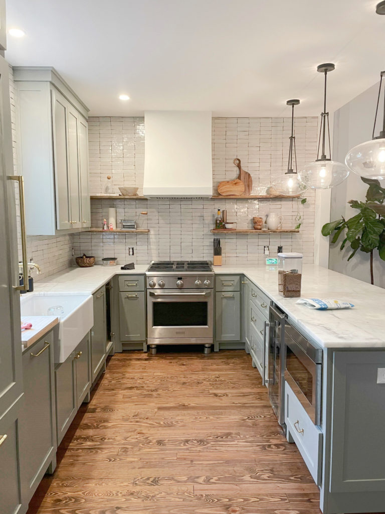 Kitchen cabinets painted Farrow and Ball Pigeon, green blue gray blend paint color, zellige tile backsplash, white quartz. Client photo from Kylie M Interiors Ed
