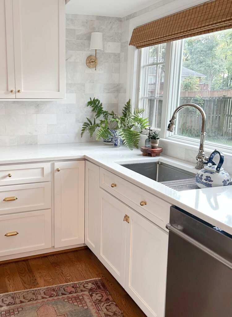 Kitchen, wood floor, MSI Miraggio Duo white quartz countertop, gold brass cabinet hardware, Benjamin Moore Chantilly Lace Kylie M Interiors, online paint color consulting, marble subway tile backsplash.