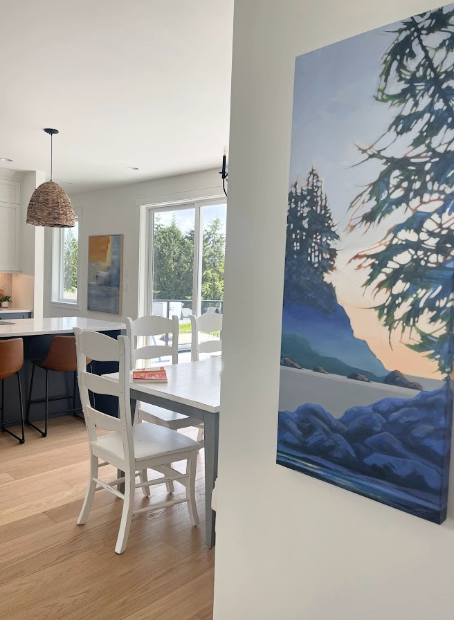 Ronei artist, acrylic westcoast ocean landscape painting. White oak flooring, Benjamin MOore White Dove walls. Open layout dining room and kitchen, Kylie M