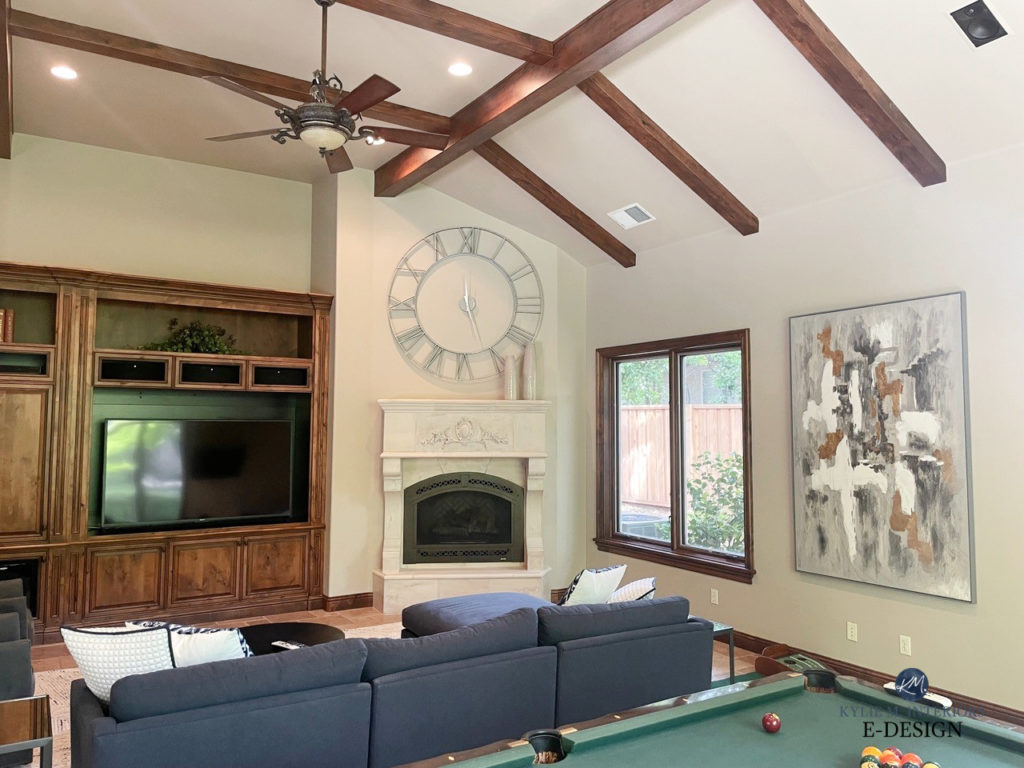 Sherwin Williams Pavillion Beige, games family room with green felt pool table, travertine tile floor and fireplace, wood beams, wood trim, wood builtins, blue sectional, Kylie m