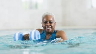 A woman performs weight training in a swim spa