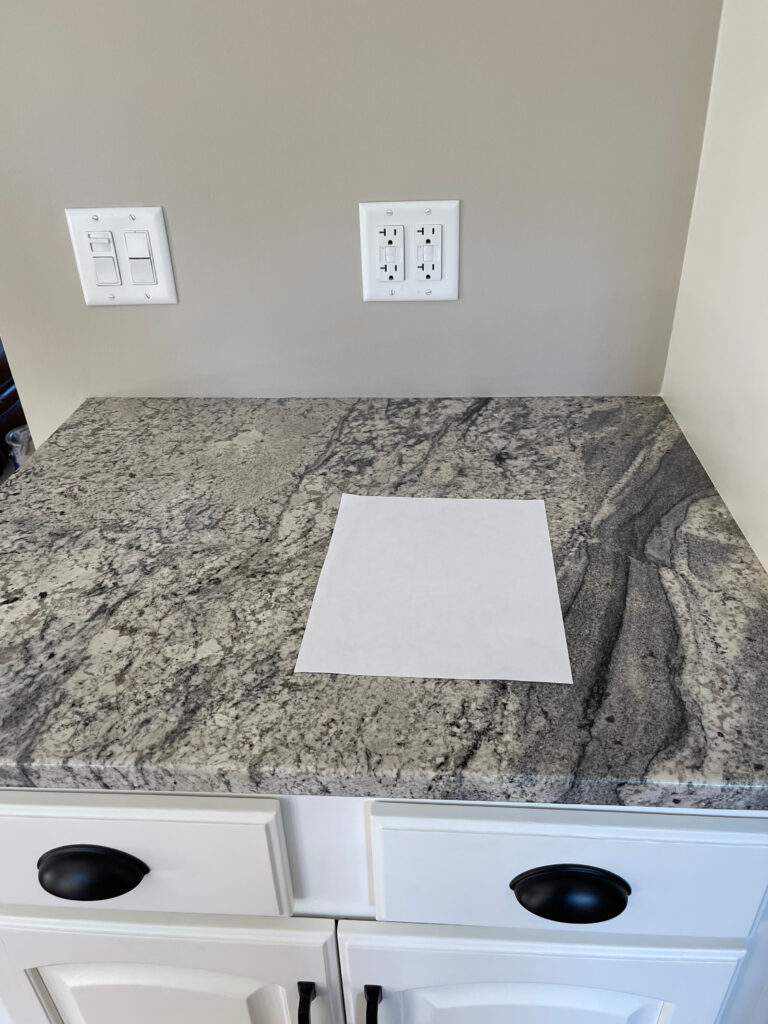 Benjamin Moore Revere Pewter wall, Cloud White painted wood cabinets, gray granite countertop. Kylie M Paint color blogger