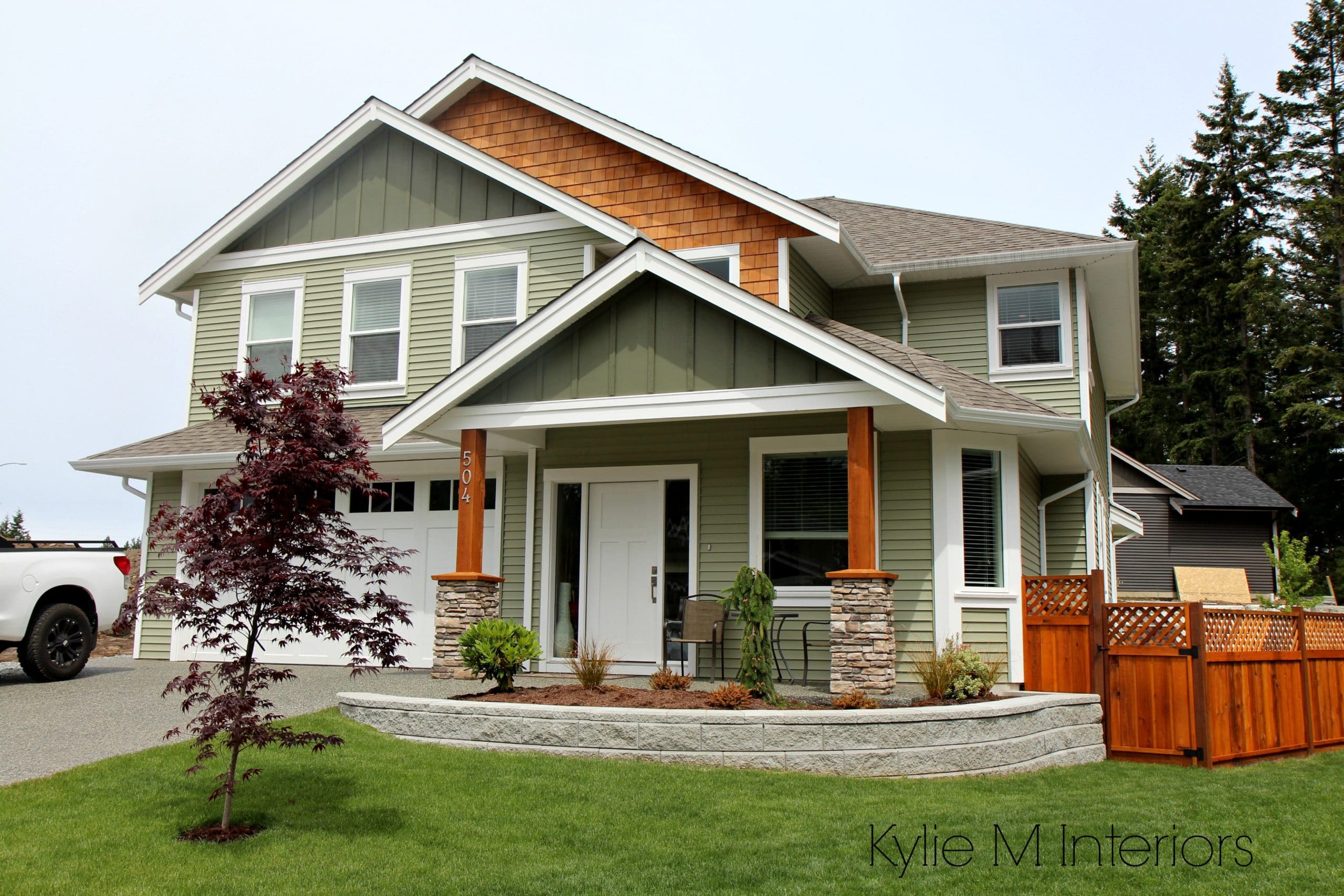 Exterior colour palette with green vinyl siding, cedar shingles and Cloud White trim by Kylie M INteriors E-decorating services