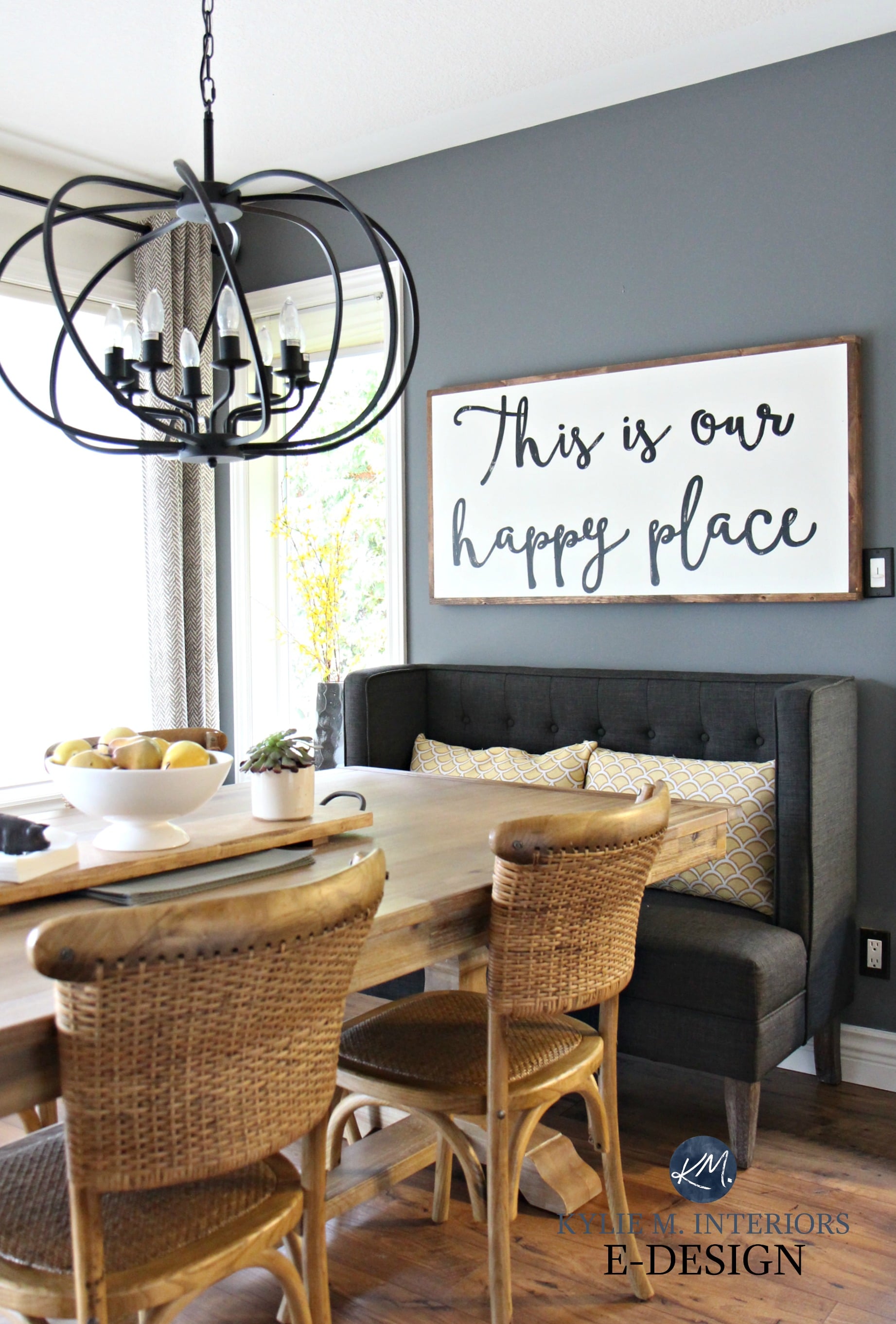 Large wood farmhouse country sign. Dining Room. Upholstered bench, wicker chairs. Benjamin Moore Steel Wool. Kylie M E-design, colour consultant