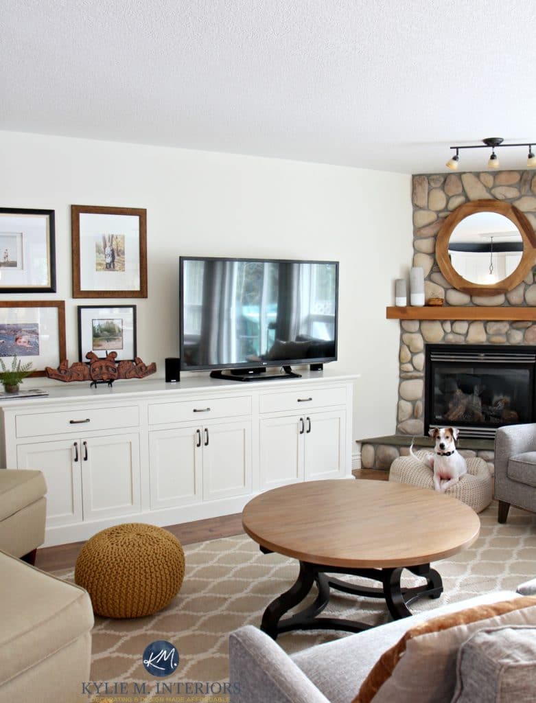 Sherwin Williams Creamy in a living room with stone fireplace, tv and large tv stand and art gallery