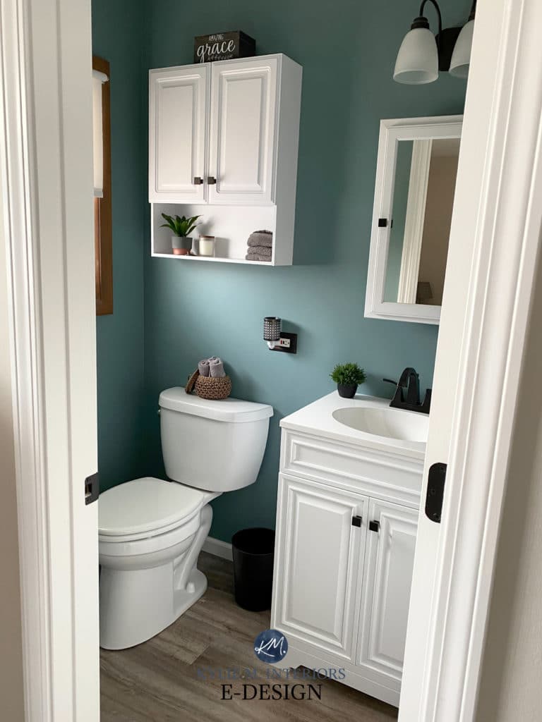 Sherwin Williams Moody Blue eggshell finish in small bathroom with white vanity and tile floor. Kylie M Interiors Edesign