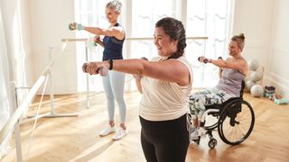 Best fitness trackers 2022: Three woman, including a wheelchair user, track their upper body strength training with the Fitbit Luxe