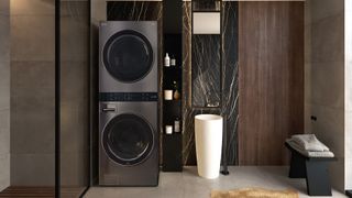 Memorial Day appliance sales | LG washer and dryer tower configuration in a black modern bathroom.